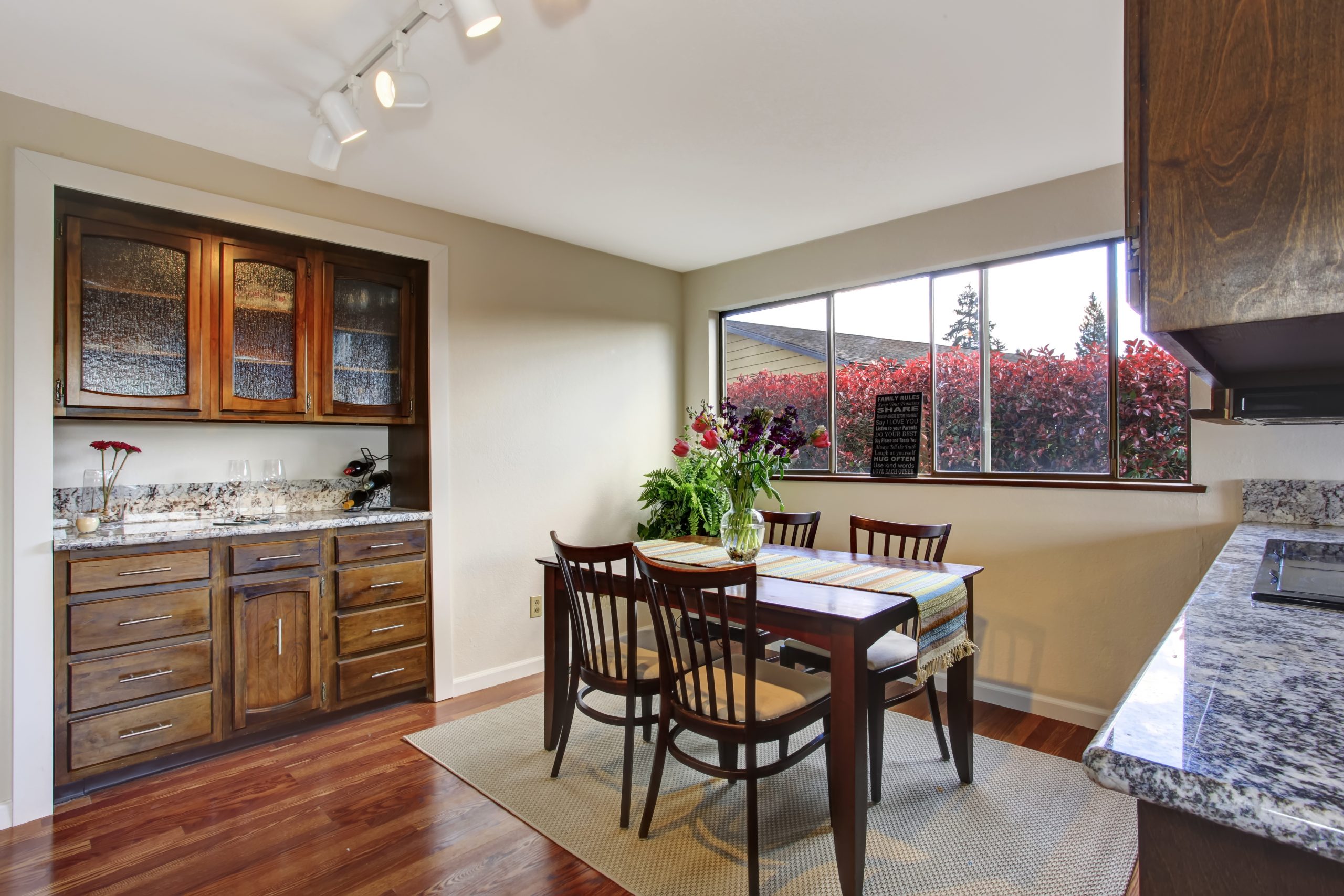 Dining,Area,With,Dark,Brown,Table,With,Fresh,Flowers,,View